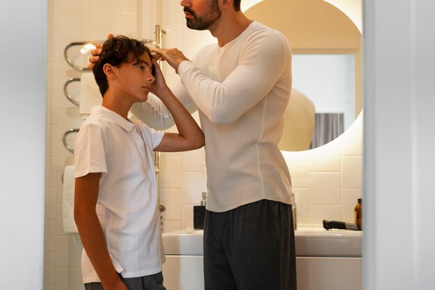 Side view father helping kid with lice