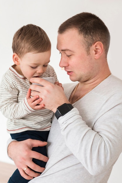 Side view of father holding baby