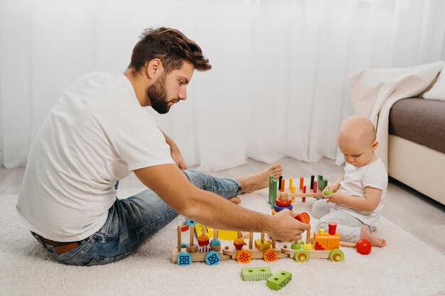 Side view of father playing with his baby