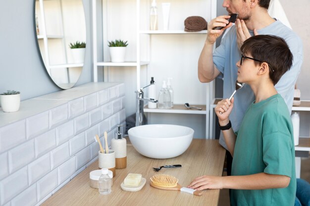 Side view father and son shaving