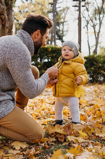 Side view of father spending time with his baby outside