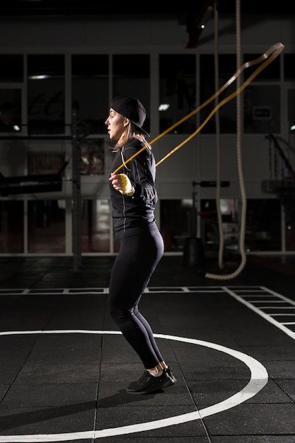 Side view of female boxer jumping rope