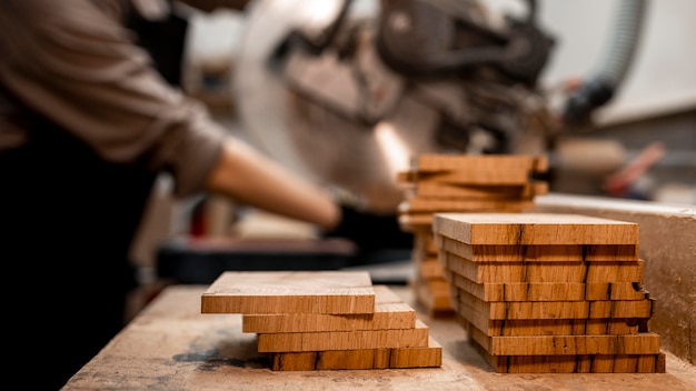 Free photo side view of female carpenter in the studio using electric saw