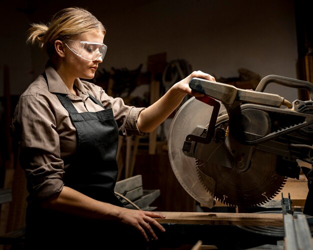 Side view of female carpenter with tool
