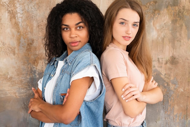 Free photo side view of female friends posing together