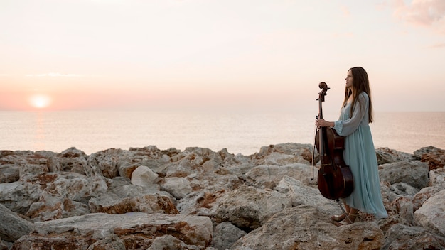 Side view of female musician with cello