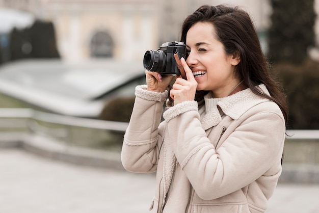 Side view of female photographer outdoors