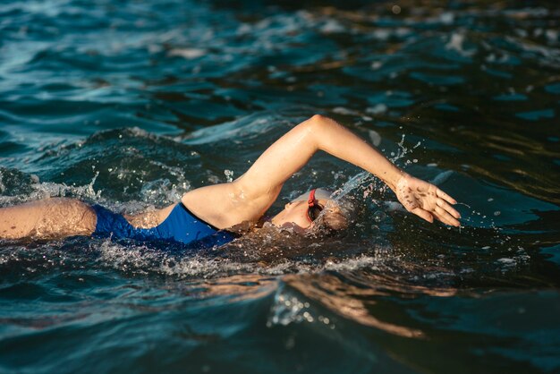 Side view of female swimmer swimming in water