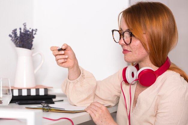 Side view of female teacher with glasses holding an online class