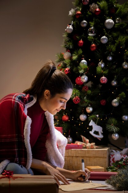 Side view female writing letter for santa claus