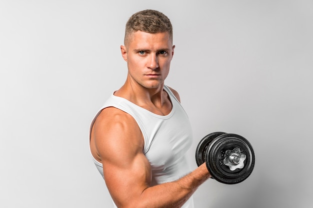 Side view of fit man working out with weight