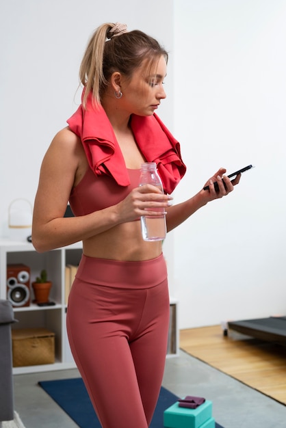 Side view fit woman exercising at home