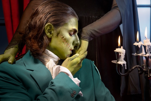 Free photo side view frankenstein kissing woman's hand