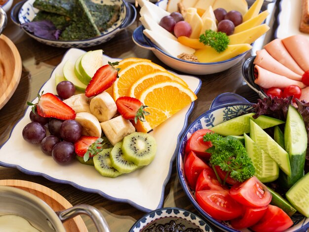 Side view of fresh fruits and vegetables on plates