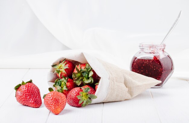 Side view fresh strawberry and strawberry jam on white background