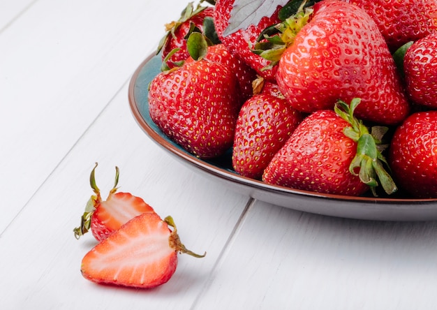 Side view fresh strawberry with basil on white background