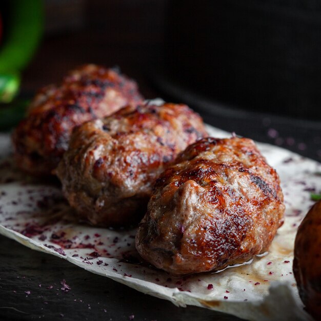 Side view fried meat in dark plate