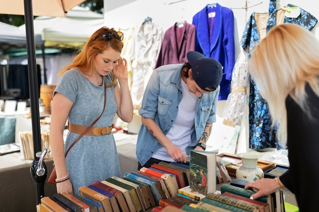 Side view friends checking old books