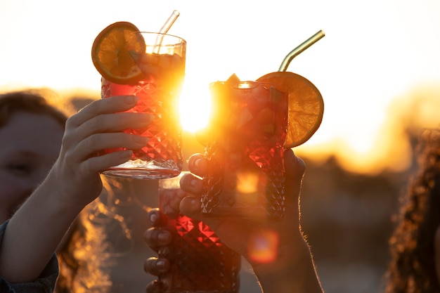 Free photo side view friends holding sangria drinks