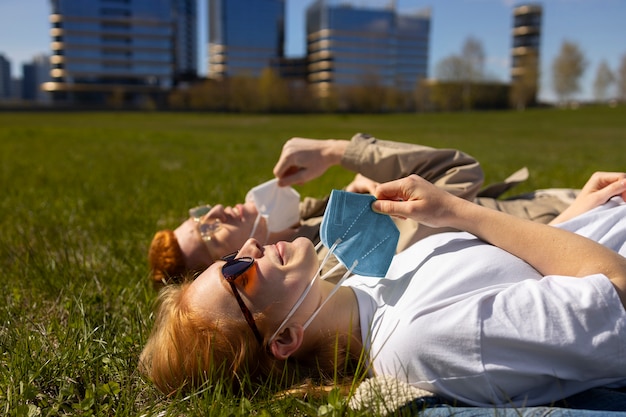 Side view friends laying on grass