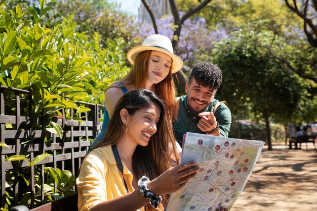 Side view friends looking at map