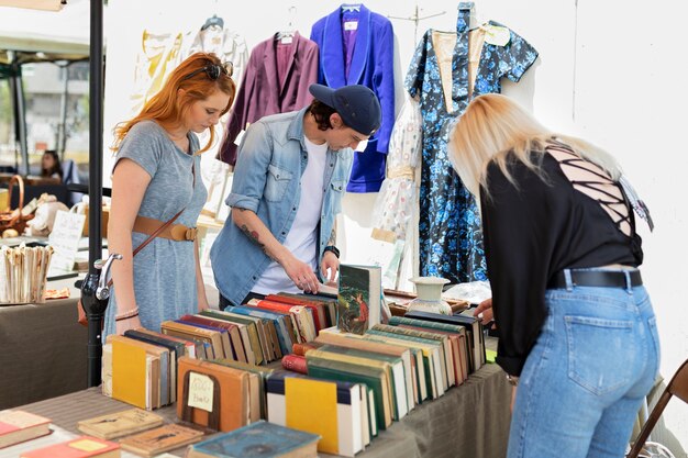 Side view friends looking at old books