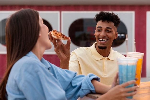 Free photo side view friends partying with food