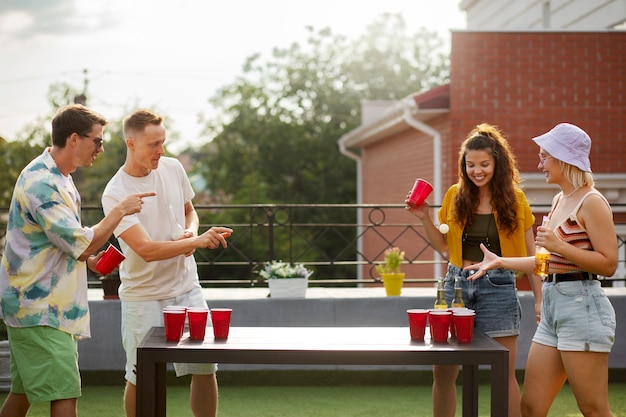 Side view  friends playing beer pong