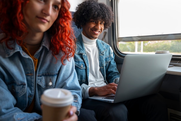 Free photo side view friends traveling by train