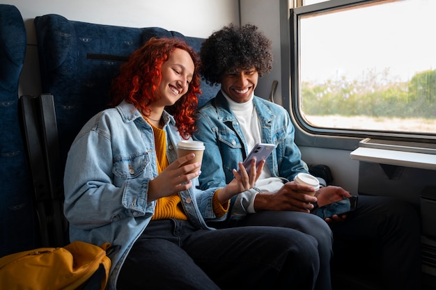 Free photo side view friends traveling by train