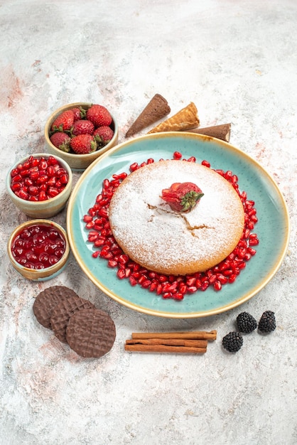 Side view from afar the appetizing cake appetizing cake with berries cookies and cinnamon