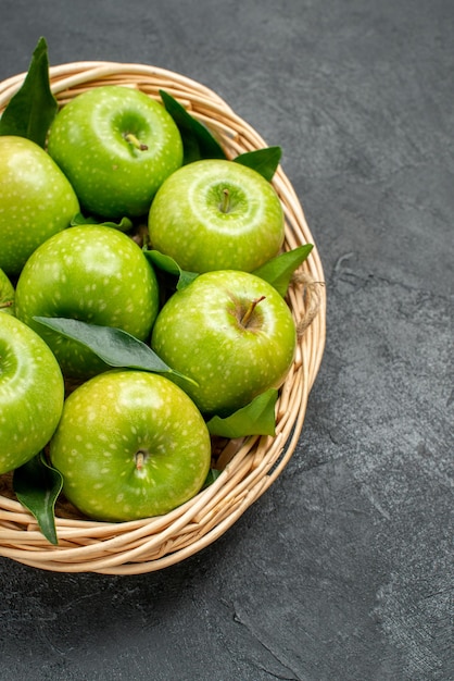 Side view from afar apples in the basket the appetizing eight apples in the wooden basket