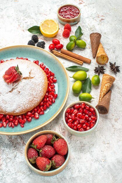 Side view from afar a cake a cake with berries citrus fruits jam lemon cinnamon star anise