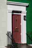 Free photo side view of front door with beige and green wall