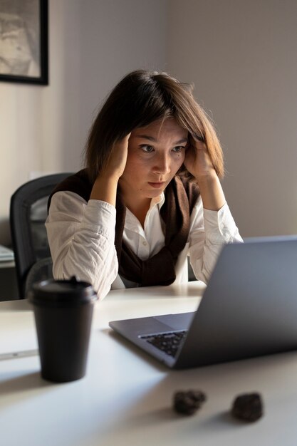 Side view frustrated woman at desk