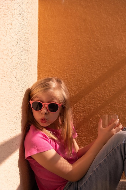 The side view of funny young girl sitting at home and smile