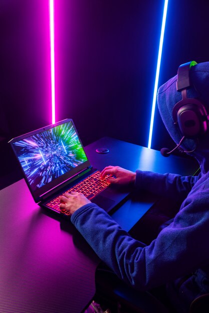side view gamer playing on laptop