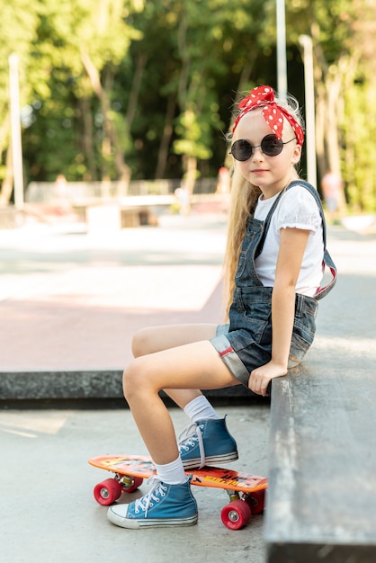 Side view of girl in blue overalls