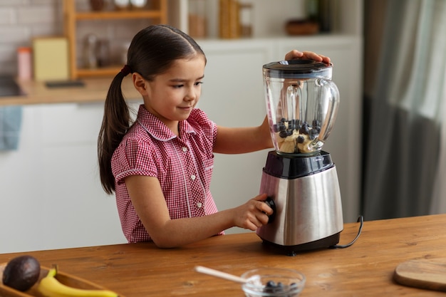 Free photo side view girl cooking at home