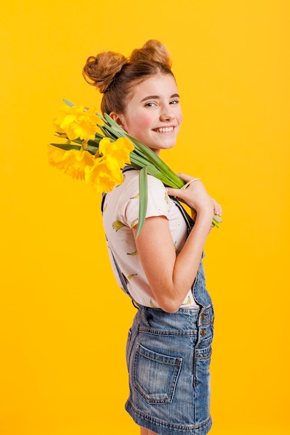 Side view girl holding flowers