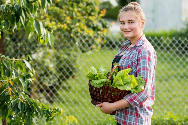 Side view girl holding lettuce basket