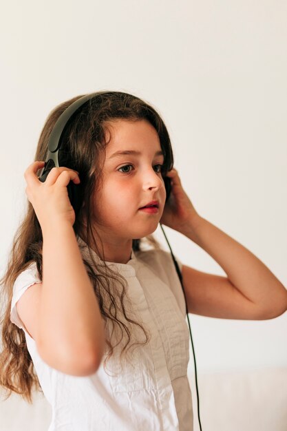 Side view girl listening to music 