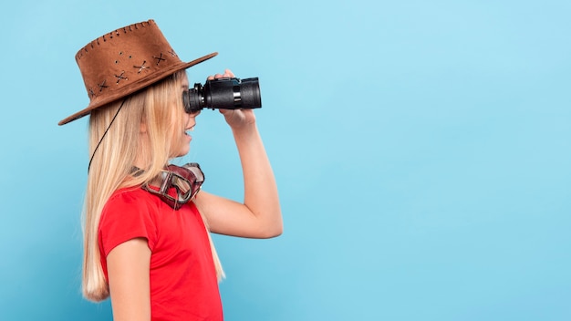 Side view girl looking with binocular