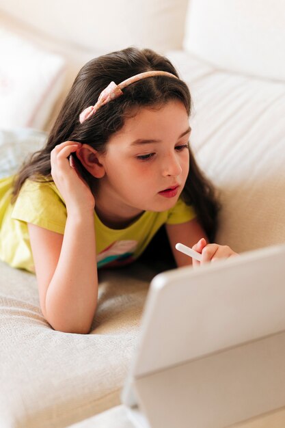 Side view girl paying attention to her tablet