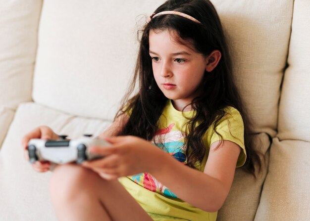 Side view girl playing video games with controller