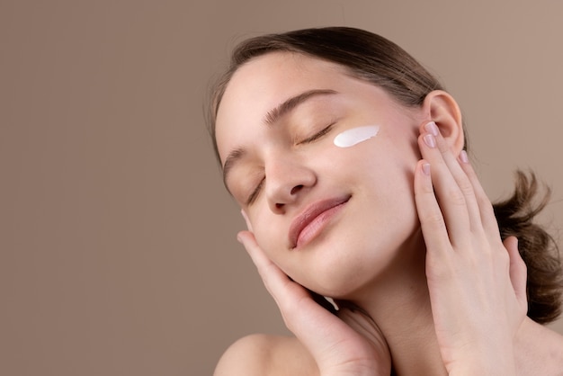 Side view girl posing with eye cream