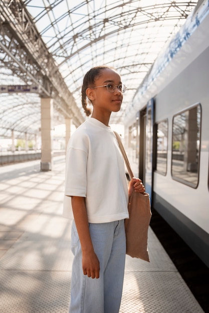 Free photo side view girl traveling by train