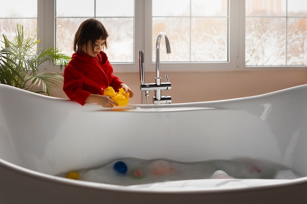 Free photo side view girl wearing bathrobe