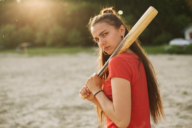 Side view girl with baseball bat 