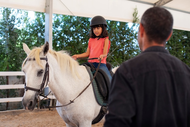 Side view girl with beautiful horse